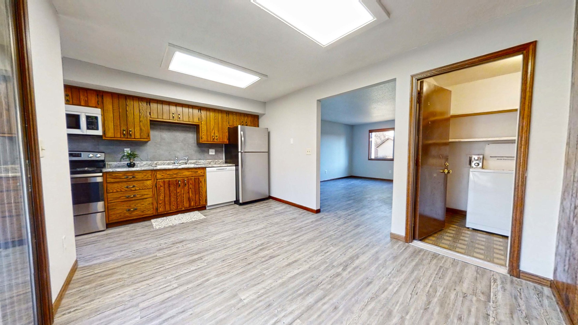 1302 Christopher Circle, Unit 4 Urbana, IL 61802 - Photo 4 of 14 a view of kitchen with stainless steel appliances wooden floor and a living room