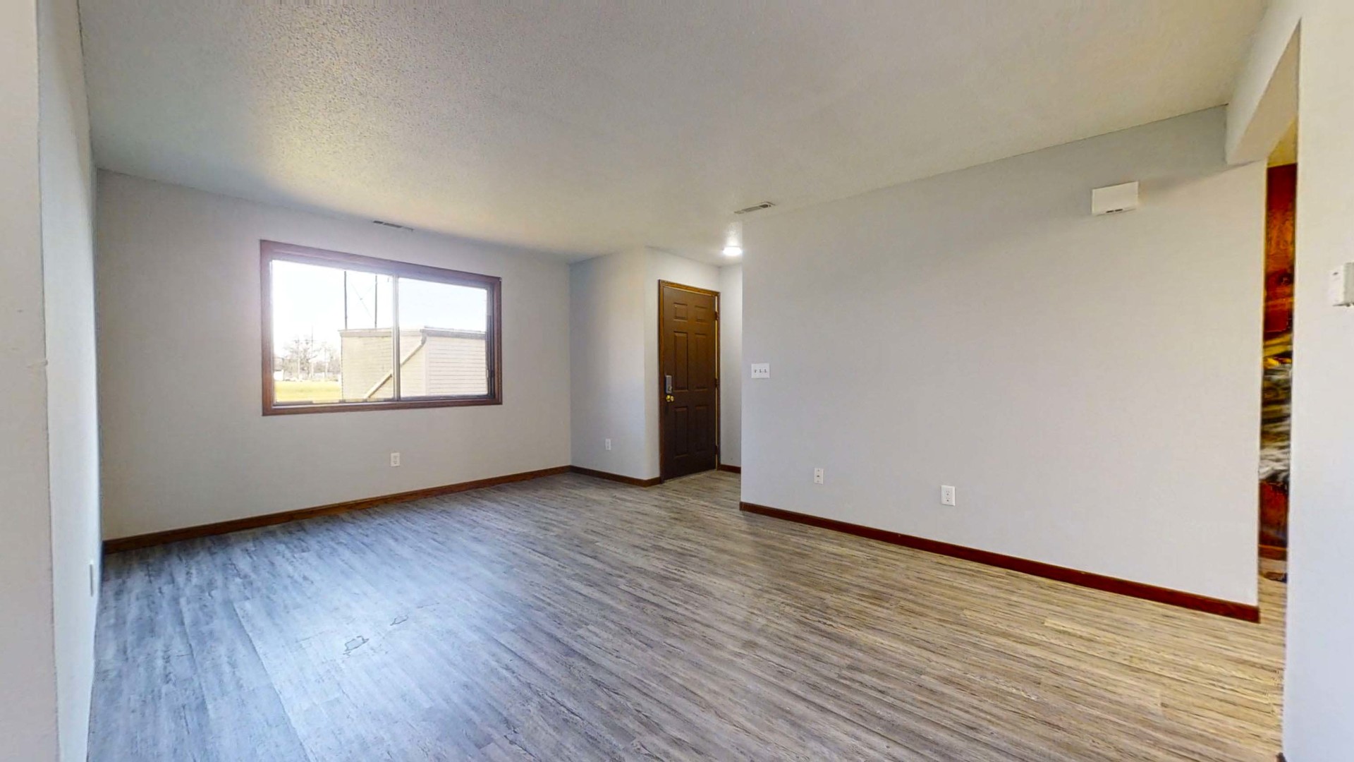 1302 Christopher Circle, Unit 4 Urbana, IL 61802 - Photo 6 of 14 an empty room with wooden floor and windows