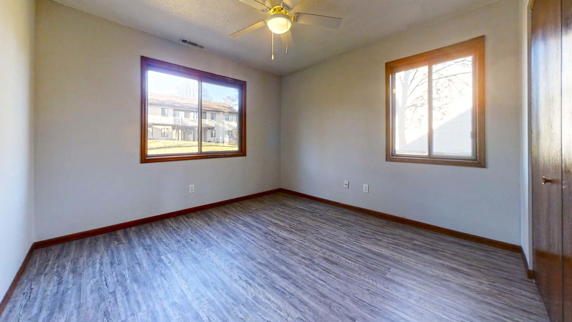 1302 Christopher Circle, Unit 4 Urbana, IL 61802 - Photo 8 of 14 a view of an empty room with wooden floor and a window