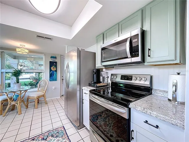 a kitchen with a stove a sink and a microwave