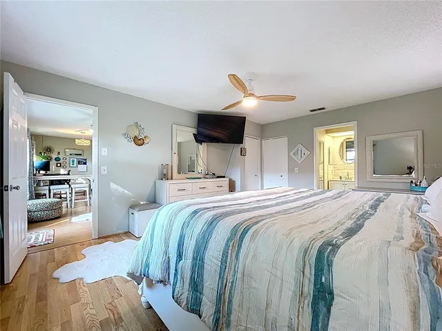 a bed room with a bed and a large mirror