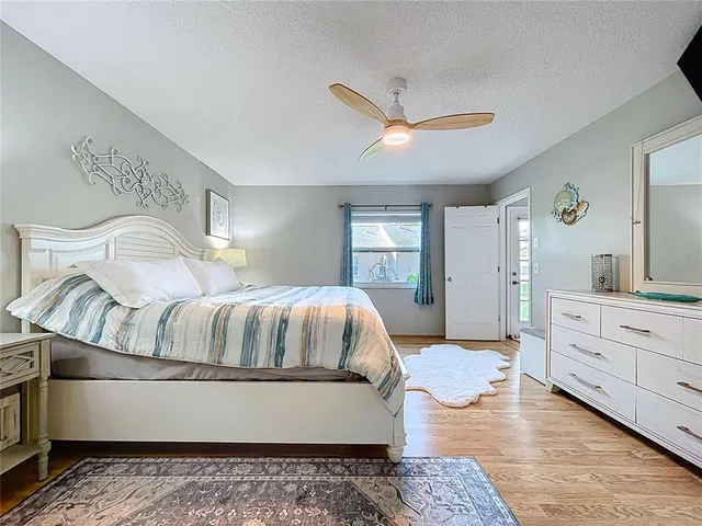 a bedroom with a large bed and a chandelier