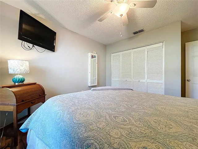 a bedroom with a large bed and a flat screen tv