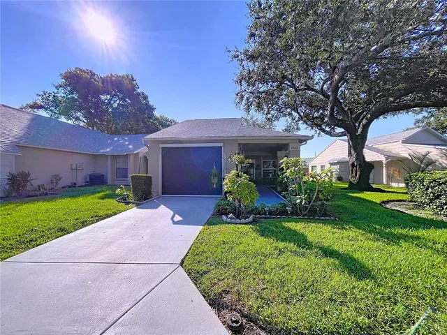 a front view of a house with a yard and a garden