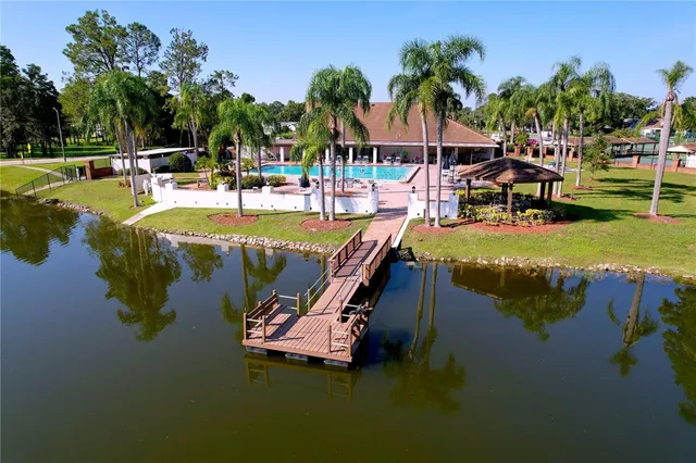 a swimming pool with outdoor seating and yard