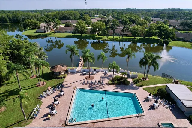 an aerial view of a house with garden space and lake view