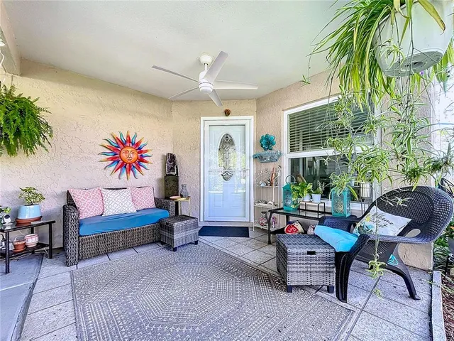a living room with furniture and a potted plant