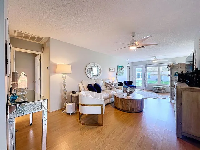 a living room with fireplace furniture and a wooden floor
