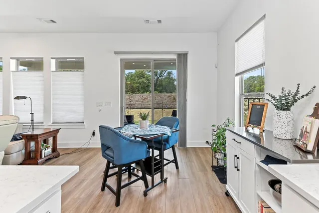 a kitchen with stainless steel appliances a stove and white cabinets