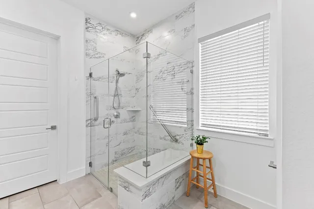 a spacious bathroom with a double vanity sink mirror and next to a window