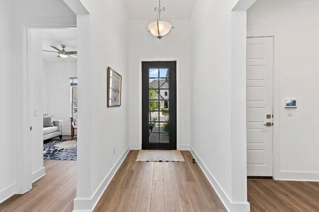 a view of yellow house with potted plants