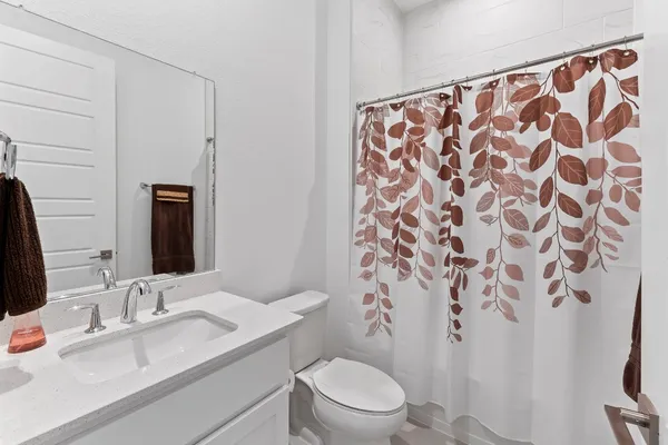 a living room with furniture a flat screen tv and a floor to ceiling window