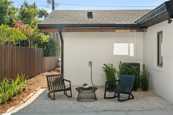 a view of a chairs and table in the patio