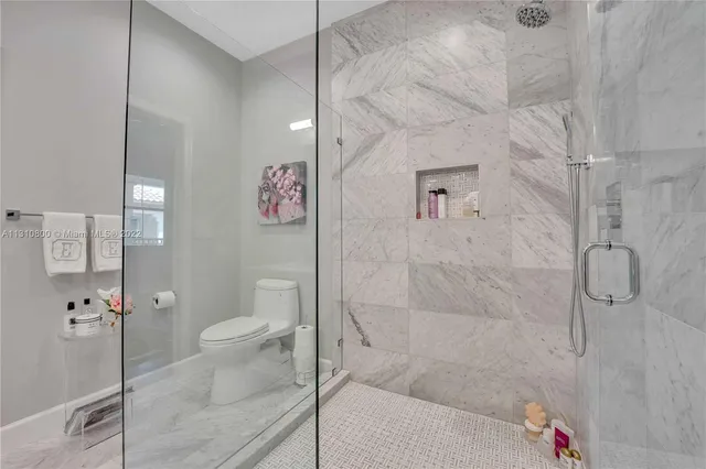 a bathroom with a shower and a toilet