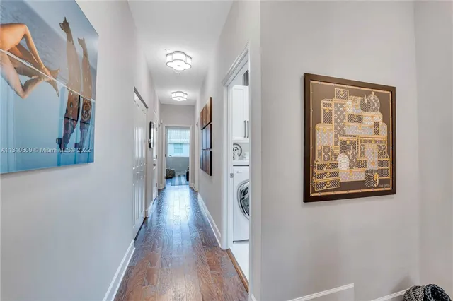 a view of a hallway with wooden floor and entryway