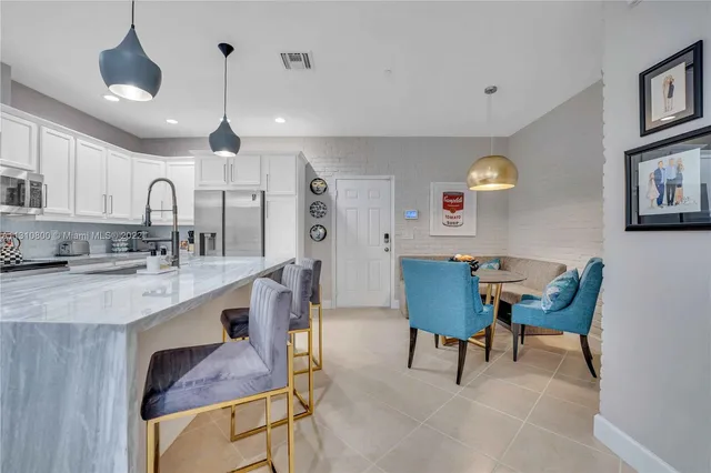 a view of kitchen and dining area with furniture