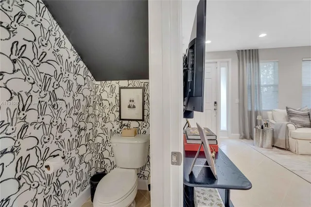 a bathroom with a toilet and a shower curtain
