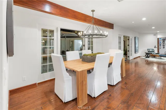 a view of a dining room with furniture wooden floor and chandelier