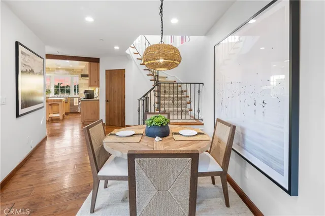 a view of a dining room with furniture wooden floor and chandelier