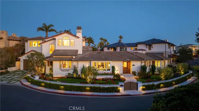 a view of a house with a yard and potted plants