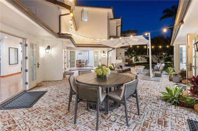 a view of an outdoor dining space with a table and chairs