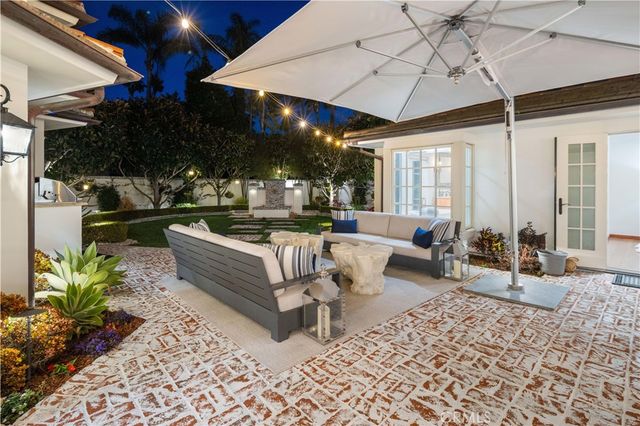 a living room with furniture a chandelier and a dining table