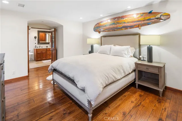 a large bed sitting in a bedroom next to a window