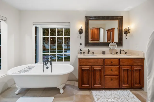 a spacious bathroom with a double vanity sink double mirror and a bathtub