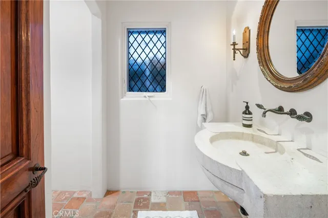 a bathroom with a sink and a mirror