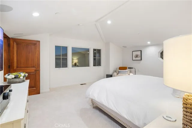 a bedroom with a bed and a couch