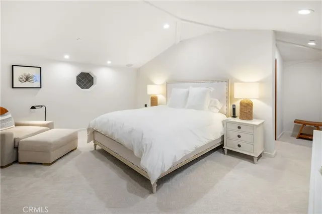 a spacious bedroom with a bed and a large window