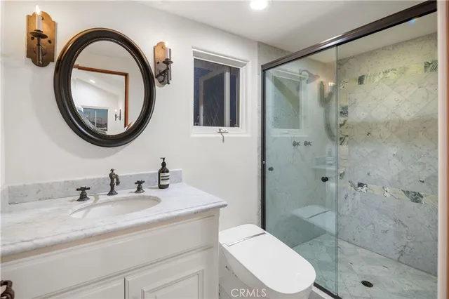 a bathroom with a toilet a sink and a mirror