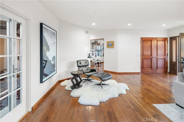 a living room with furniture and a hard wood floor