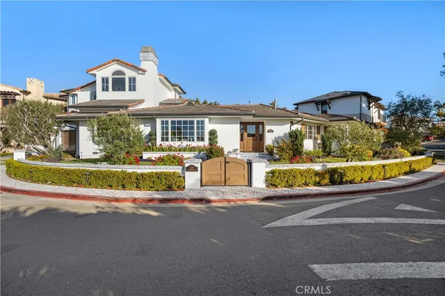 a front view of a house with a garden and plants