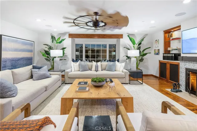 a living room with furniture fireplace and a large window