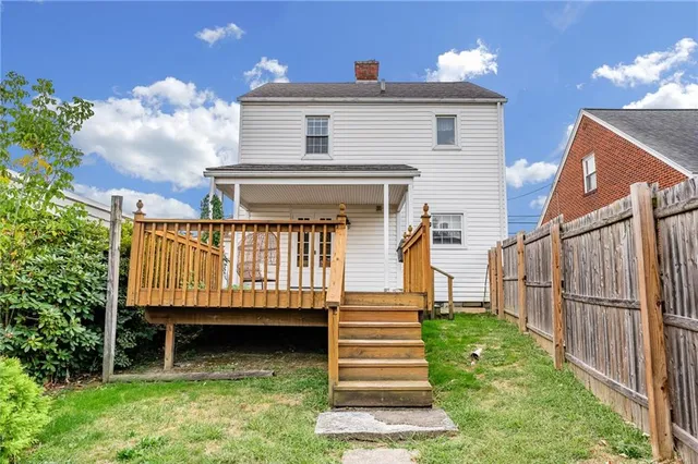 a view of a house with wooden fence