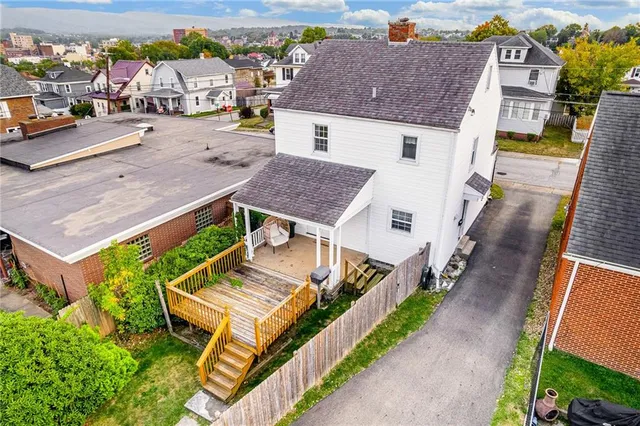 an aerial view of a house with a big yard