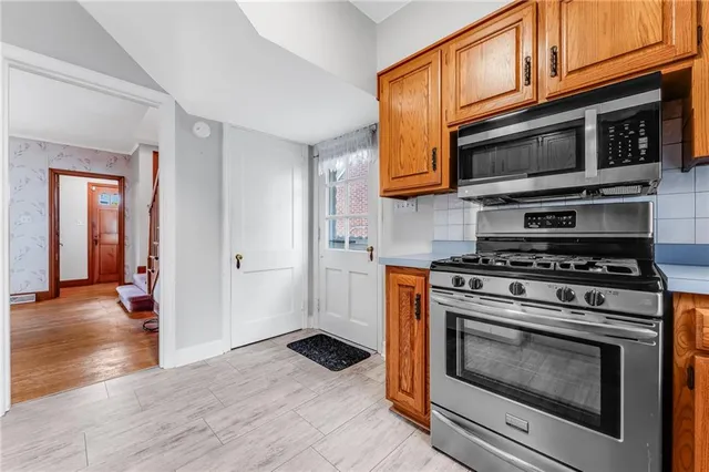 a kitchen with stainless steel appliances a stove microwave and cabinets