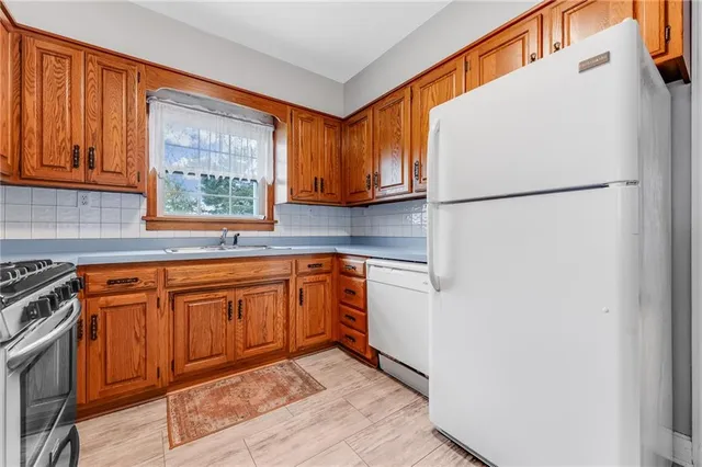 a kitchen with stainless steel appliances granite countertop a refrigerator sink and cabinets