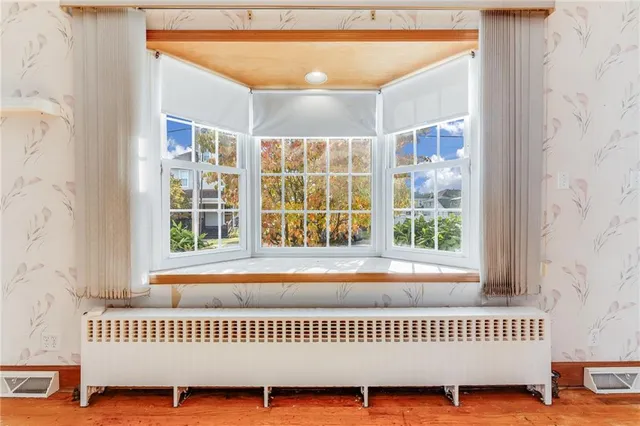 a view of a bedroom with a window and a chandelier