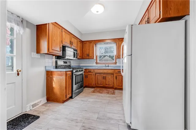 a kitchen with a sink cabinets and appliances