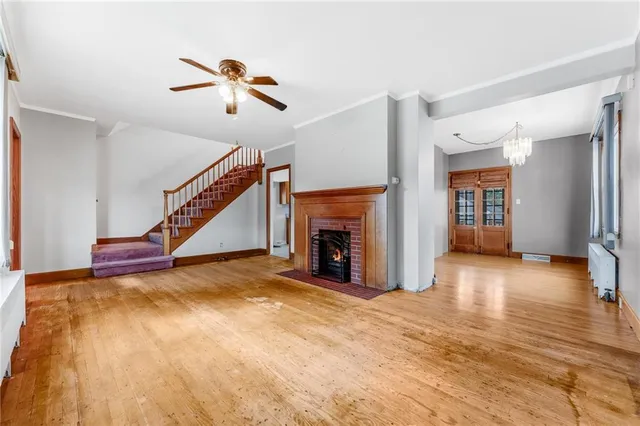 a view of empty room with fireplace and fan