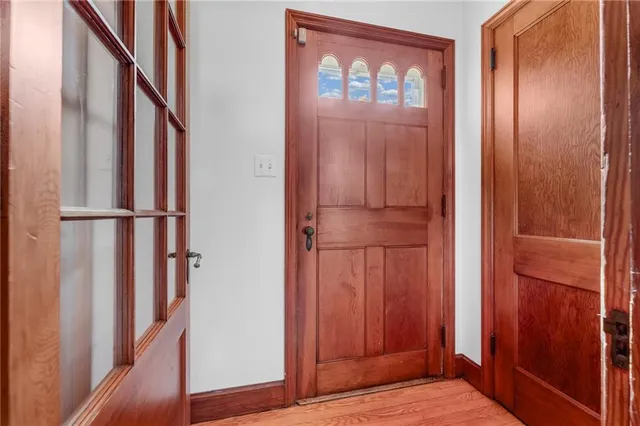 a view of front door with wooden floor