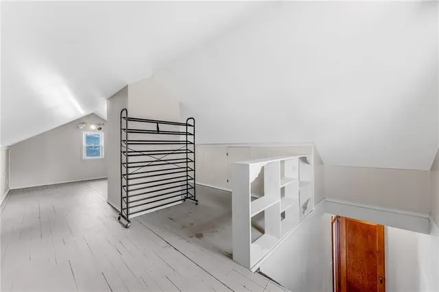 a view of a livingroom with stairs and a window