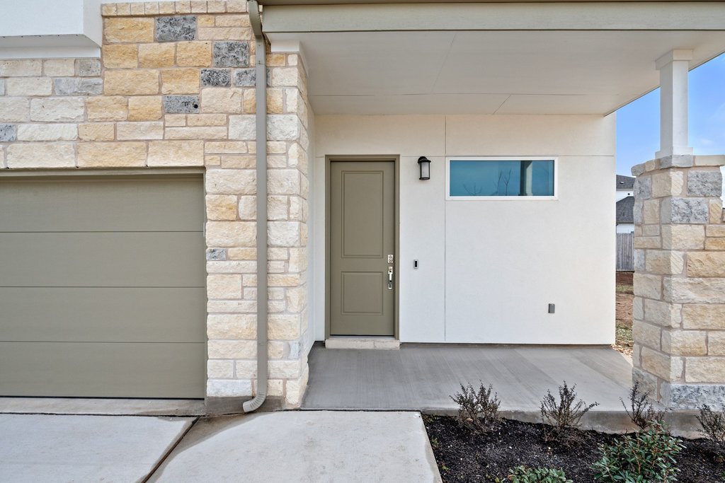 2205 Cento Walk Round Rock, TX 78664 - Photo 2 of 32 Entrance to property featuring stone siding and a garage