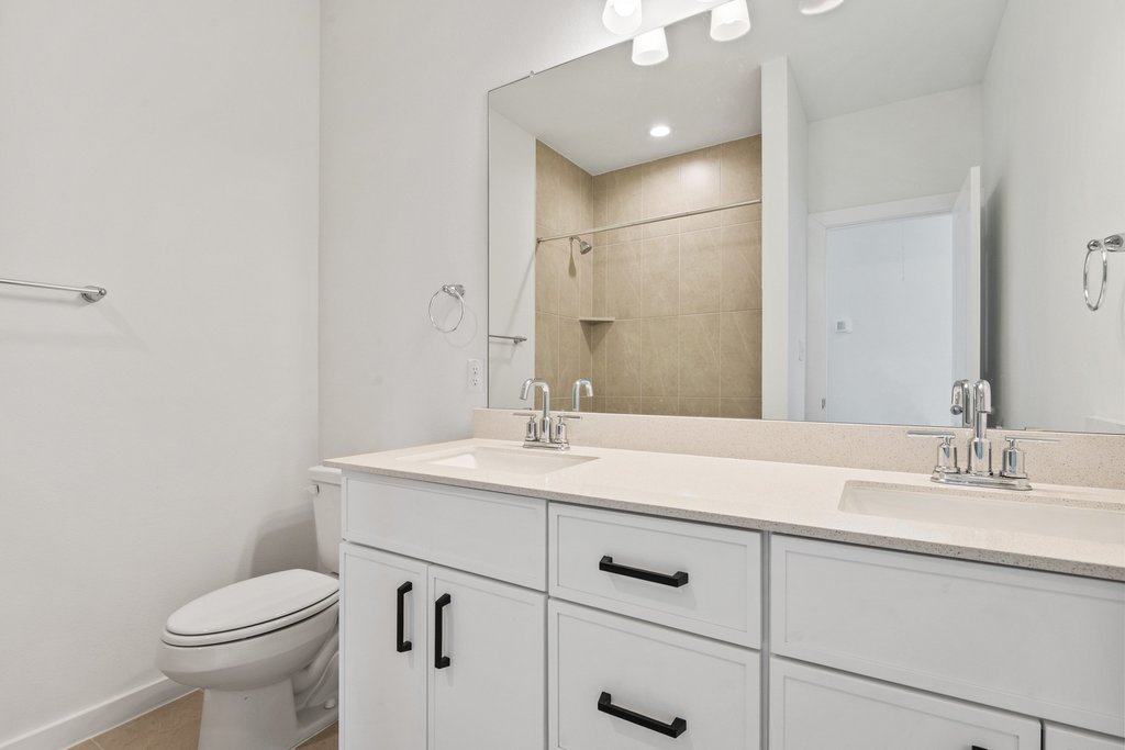 2205 Cento Walk Round Rock, TX 78664 - Photo 22 of 32 Bathroom featuring double vanity and tiled shower