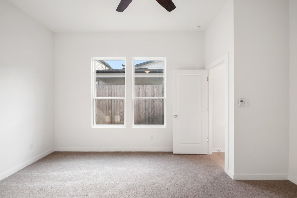 2205 Cento Walk Round Rock, TX 78664 - Photo 9 of 32 Unfurnished room with carpet and a ceiling fan