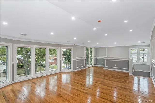 a kitchen with kitchen island stainless steel appliances a sink a stove a microwave and cabinets