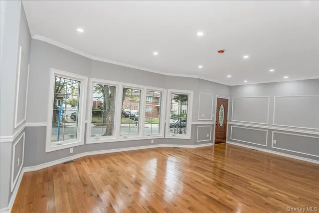 a large kitchen with stainless steel appliances granite countertop a large counter top and a wooden floors