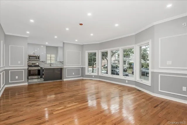 a kitchen with stainless steel appliances kitchen island a stove sink and microwave